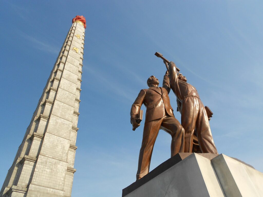 The Juche Tower, and the statue of the emblem of the Workers' Party of Korea, Pyongyang, North Korea
